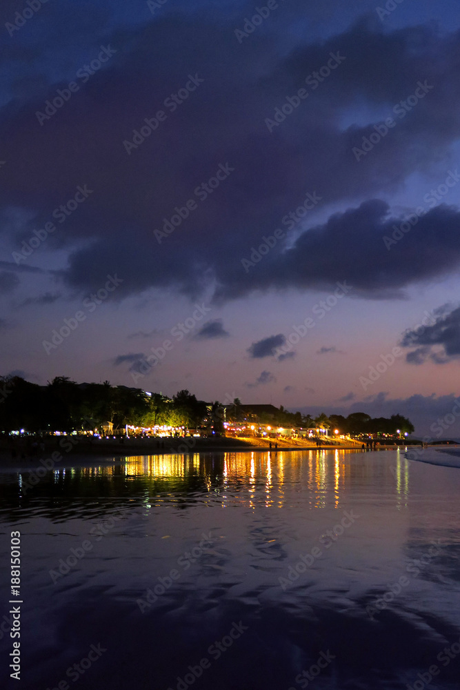 Night lights reflection after sunset at Kuta beach, Bali, Indonesia