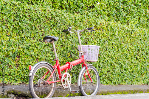 Red bucycle at the green wall photo