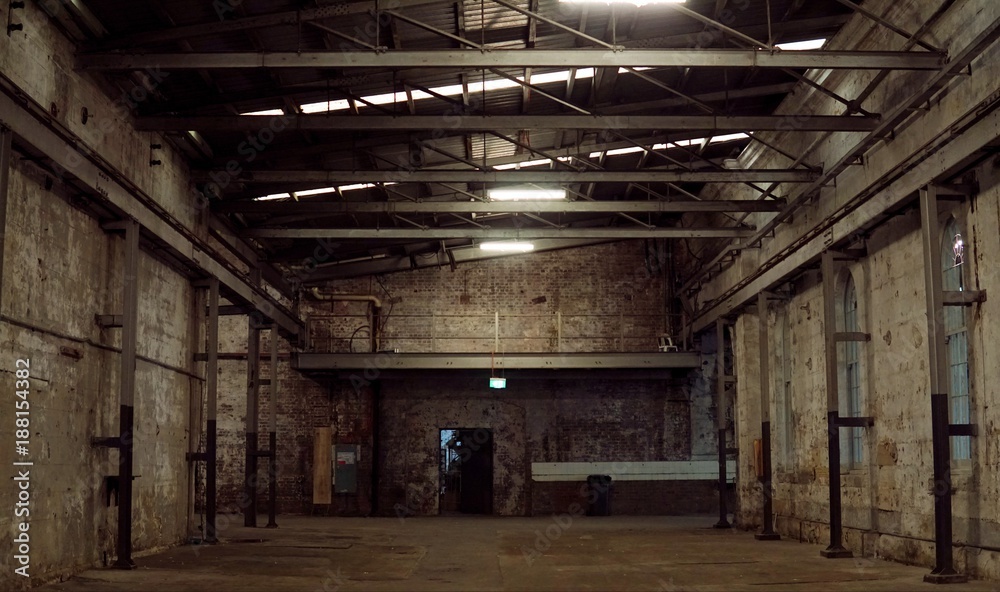 Inside of old abandon factory. A structure interior of empty industry warehouse. An abandon old factory with no equipment and machine. Image of rustic factory room structure made from iron and steel.