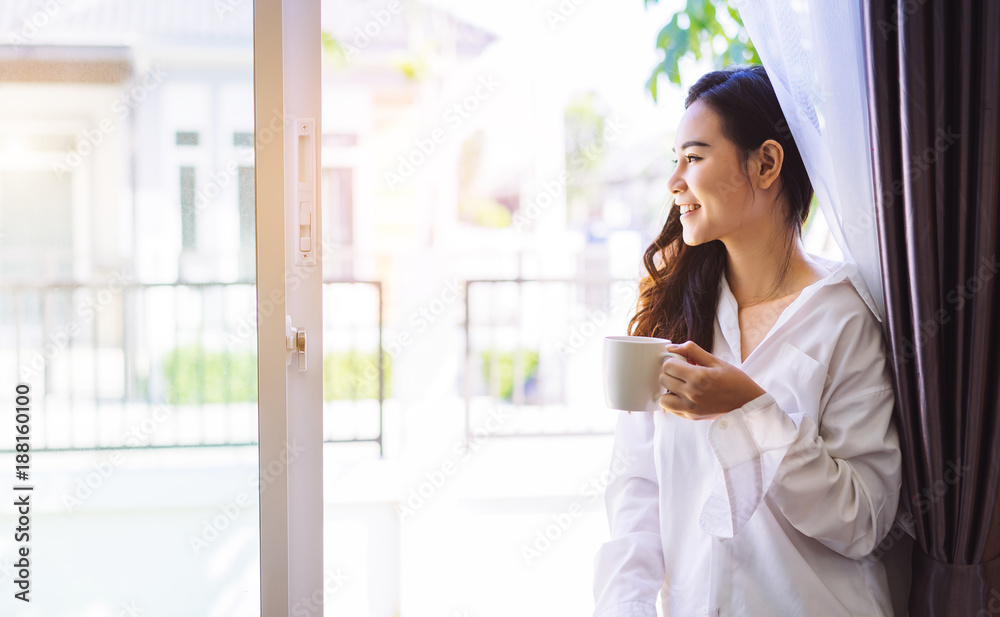 Asian woman drinking coffee in the morning breakfast in window bedroom fresh start the day happiness relax at home healthy lifestyle concept Asian woman drinking coffee in the morning breakfast in window bedroom fresh start the day happiness relax at home healthy lifestyle concept
