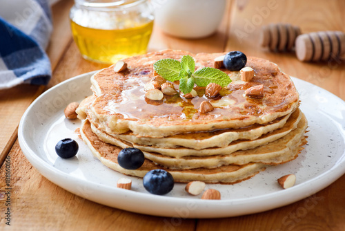 Gluten free almond pancakes with blueberries and honey. Closeup view