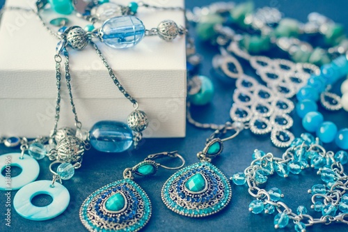 Accessories and decorations on a black background, gift box, earrings, bracelets, necklace
