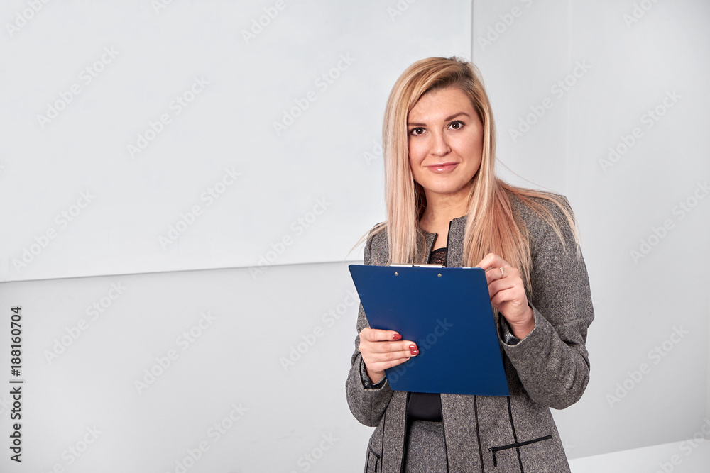 business woman standing with clipping board in the office and ready to write something. business woman standing with clipping board in the office and ready to write something.