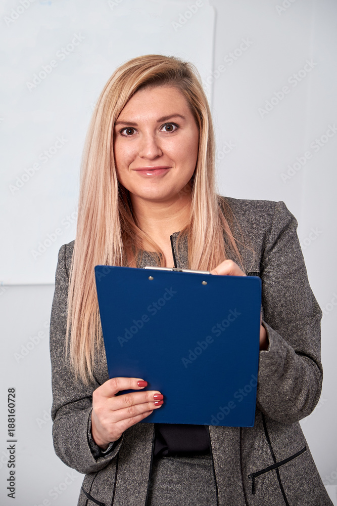 business woman standing with clipping board in the office and ready to write something. business woman standing with clipping board in the office and ready to write something.