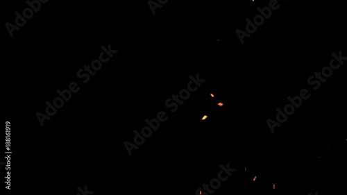 Red hot embers rising in the dark of night photo