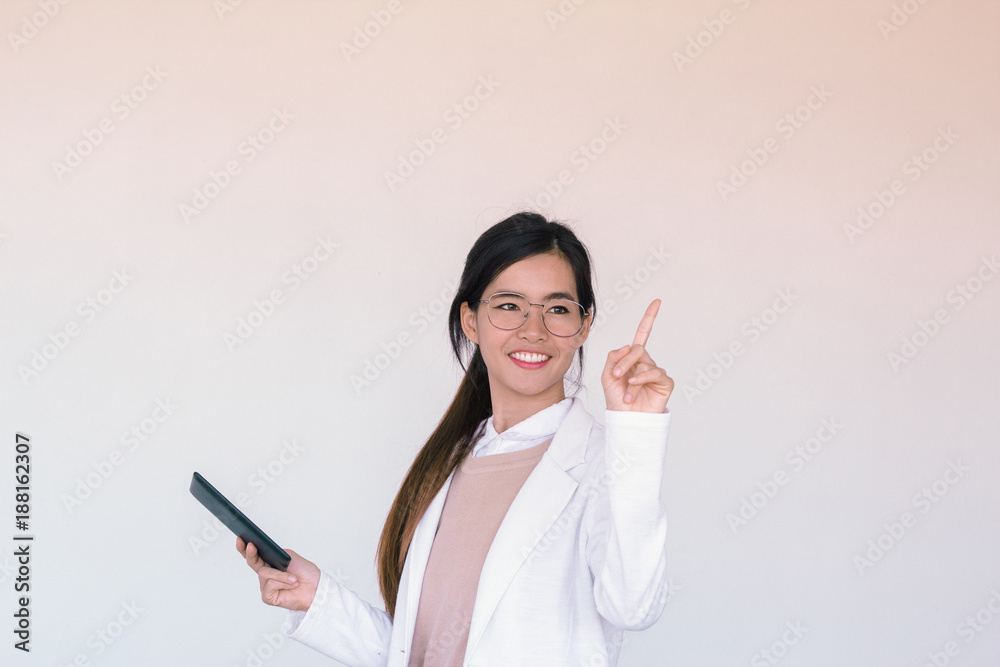 Young Asian businesswoman wearing white suit and holding a tablet Young Asian businesswoman wearing white suit and holding a tablet
