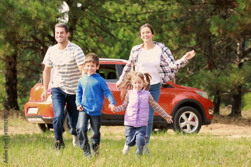 Happy family having fun out...