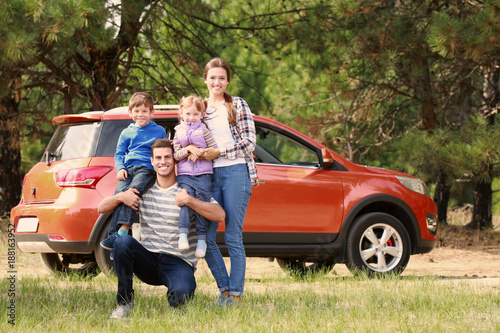 Happy family near modern ca...