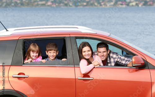 Happy family traveling by car