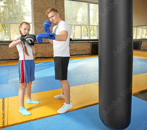 Little girl with trainer in...