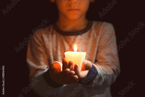 Little boy holding burning ...