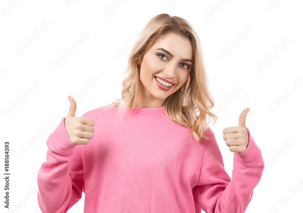Young beautiful smiling woman showing thumbs-up gesture on white background Young beautiful smiling woman showing thumbs-up gesture on white background