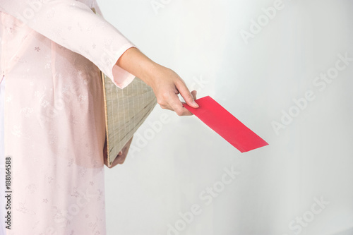 Vietnam woman holding red envelope, woman wear Vietnamese, Vietnamese new year photo