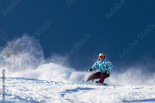 Fast snowboarder at ski slope