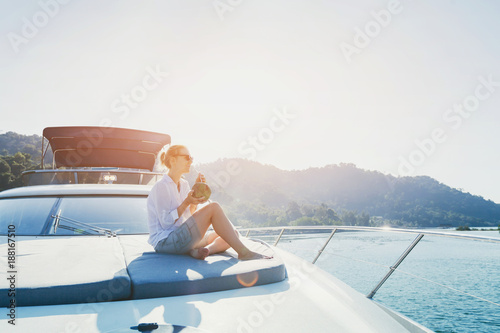 woman enjoying sunset trip onboard of luxuious yacht, luxury sea cruise travel on the boat © Song_about_summer