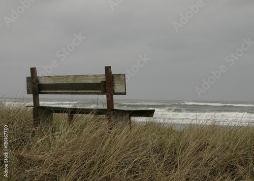 A lonely bench on the ocean shore