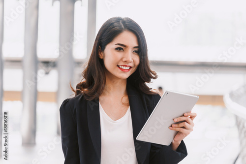 Happy successful businesswoman using a digital tablet computer Free Download Happy successful businesswoman using a digital tablet computer - GFXLoad