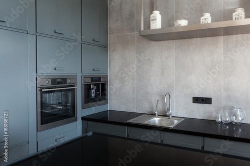 New modern white kitchen with built in oven and chrome water tap