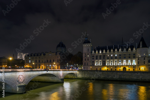 Night view of Conciergerie Castle and Pont Notre-Dame bridge