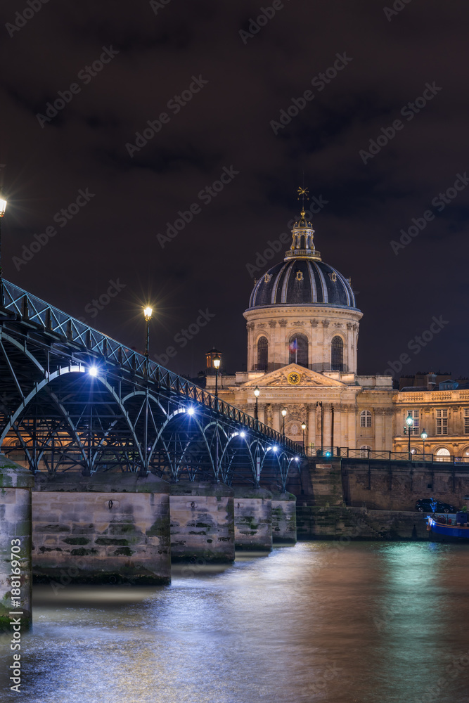 River Seine with Pont des Arts and Institut de France at night in Paris
