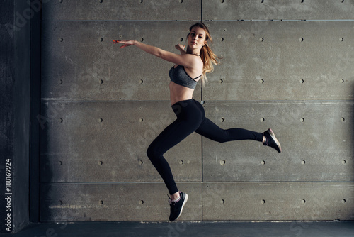 Fit young woman jumping dancing Fitness sport. © undrey
