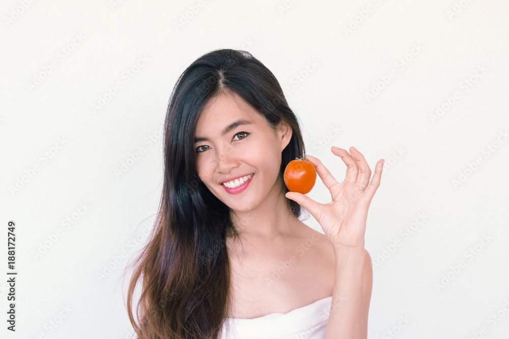 Beauty lycopene Skincare concept- Young Asian woman after shower smiling holding red tomato Beauty lycopene Skincare concept- Young Asian woman after shower smiling holding red tomato