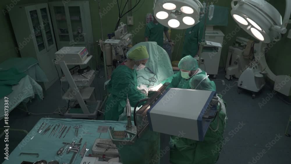Crane shot, tracking to surgical equipment, instruments and tools on sterilized tray table