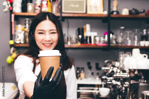 Barista holding coffee in coffee shop