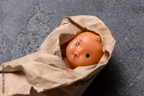 Old plastic doll, abandoned newborn concept photo