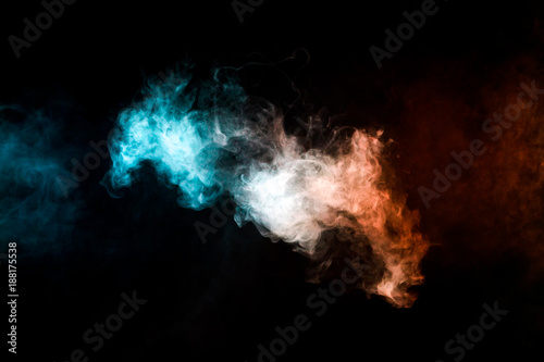 Thick colorful smoke of red and blue on a black isolated background. Background from the smoke of vape © Виталий Сова