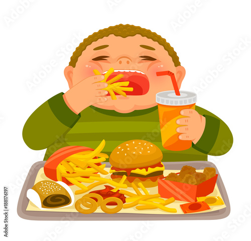 Overweight boy mindlessly eating large amounts of junk food