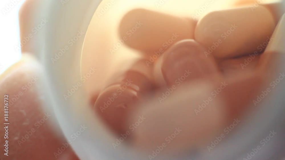 Pills in a plastic containet. Close up. Macro. Soft light from back. Pills in a plastic containet. Close up. Macro. Soft light from back.
