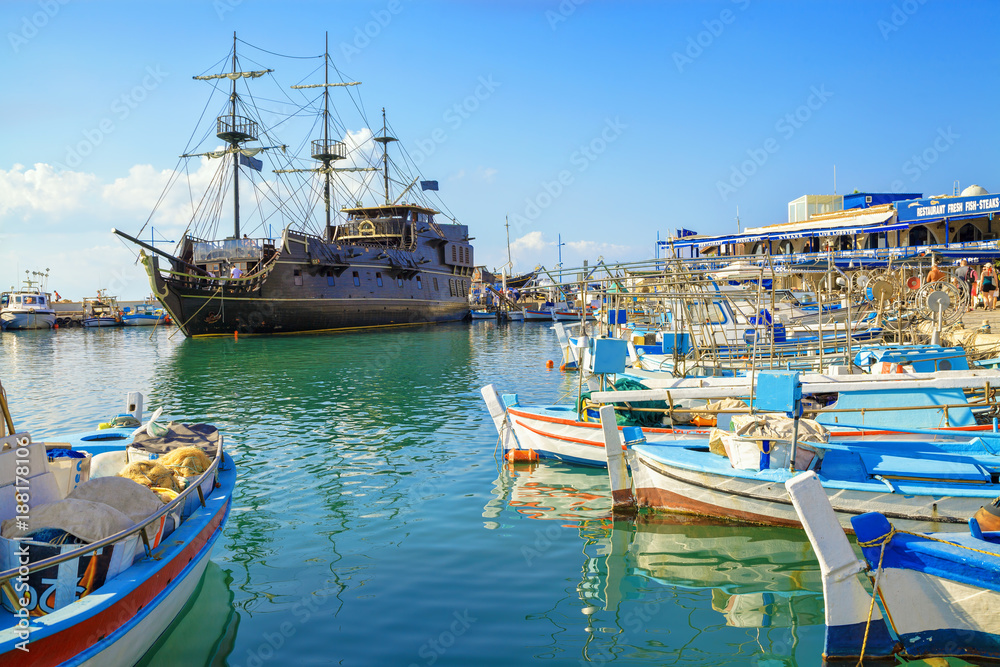 Pirate ship and fishing boats in harbor of Ayia Napa, Cyprus.
