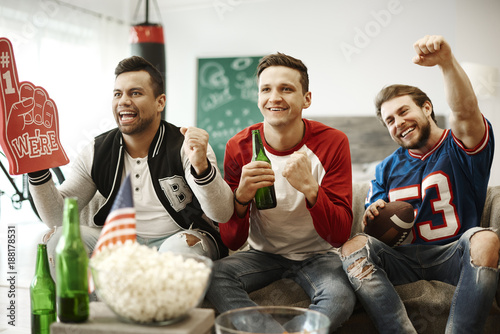 Football supporters cheering at home
