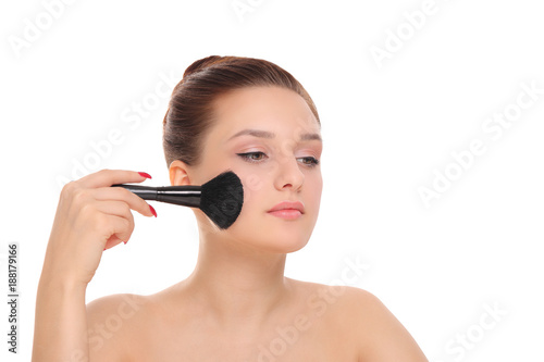 woman applying dry cosmetic powder
