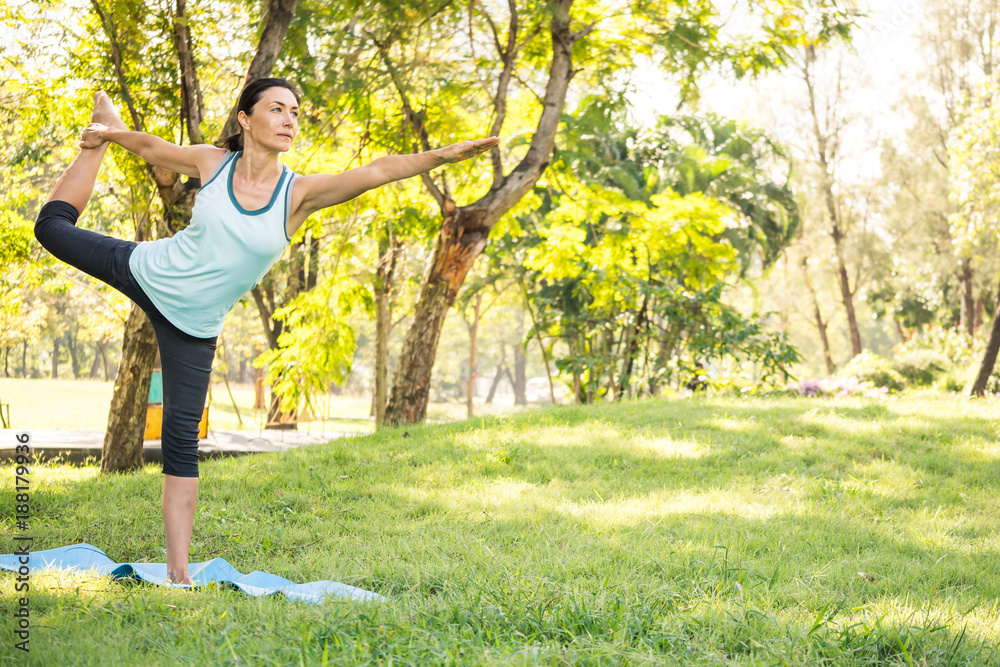 Beautiful woman doing yoga exercises in the park. Concept of healthy lifestyle. Beautiful woman doing yoga exercises in the park. Concept of healthy lifestyle.
