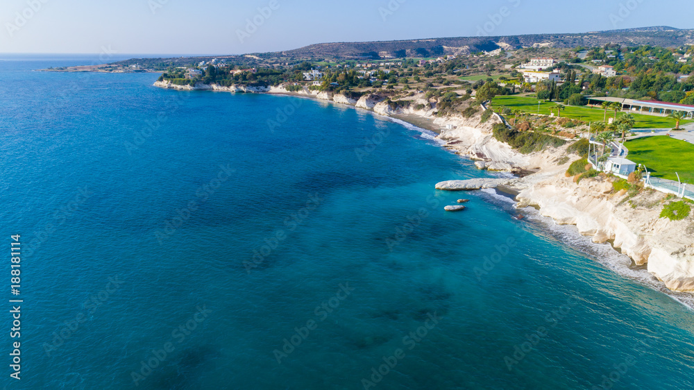 Aerial view of coastline and landmark big white chalk rock at Governor's beach, Limassol, Cyprus.The steep stone cliffs and deep blue sea waves crushing in coves at Kalymnos fish restaurant from above