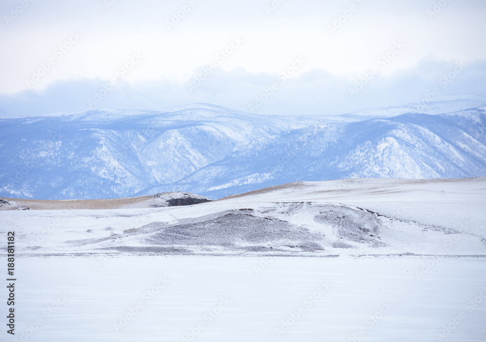Baikal lake. Winter landscape. Snowy mountain peaks