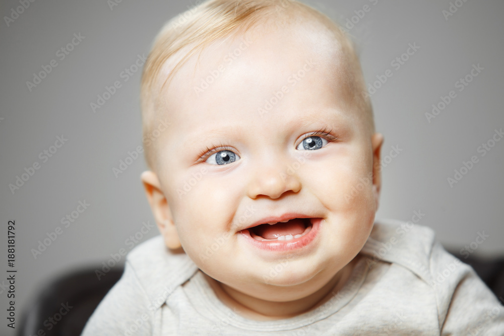 Baby with interested look and broad smile