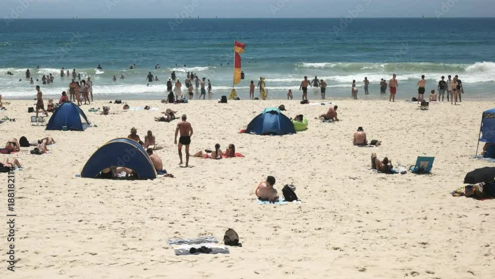 a beach-goer walks towards the water at mainbeach in surfers paradise, australia a beach-goer walks towards the water at mainbeach in surfers paradise, australia