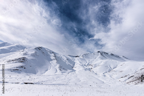 White snowy fields mountain under a beautiful blue sky © Sondem