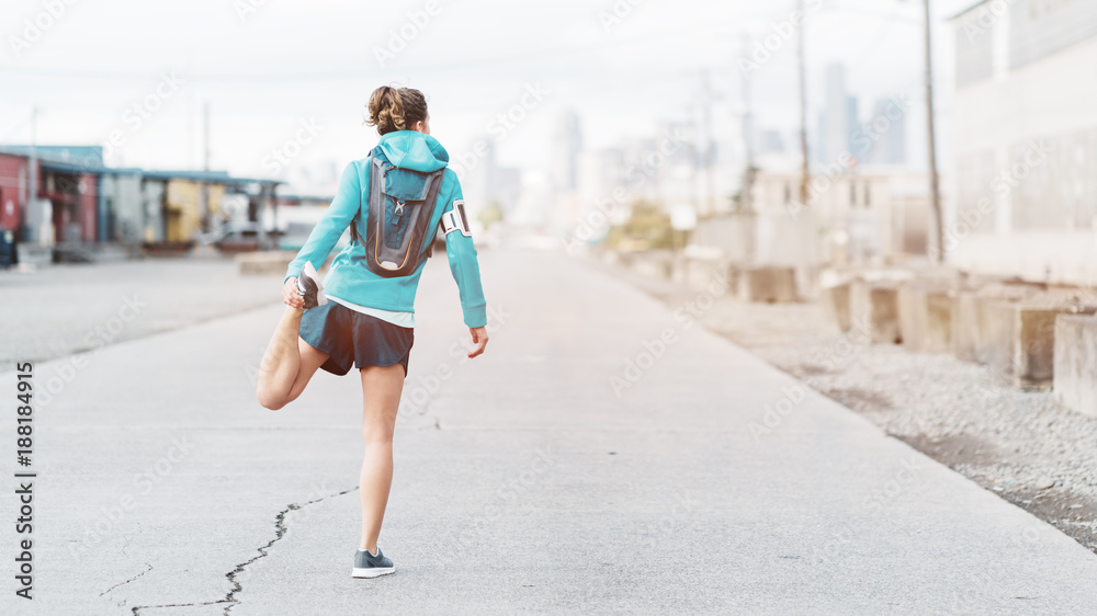 Young sporty woman with running backpack exercising in urban zone