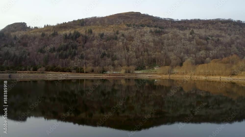 Mountains and Forests Reflected in a Calm Lake at Sunset Mountains and Forests Reflected in a Calm Lake at Sunset