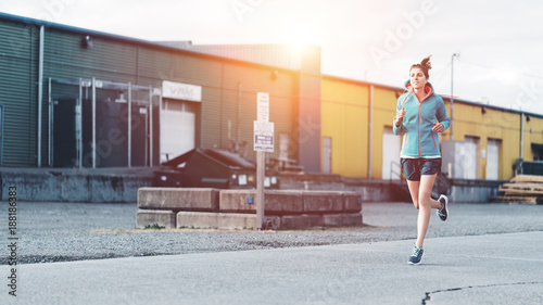 Young sporty woman jogging alone in the urban area