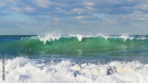 Blue waves and white foam in the morning light © Stphanie