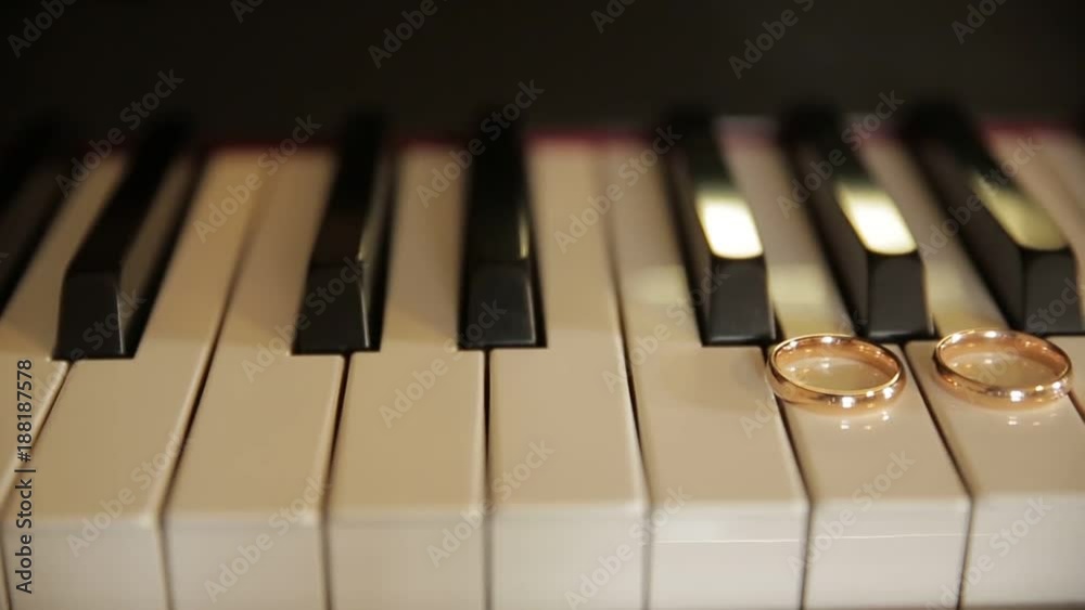 wedding rings on the keys of the old piano