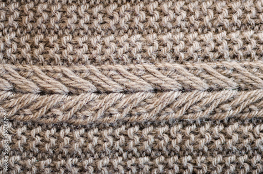 Knitted texture. Pattern fabric made of wool. Background, copy space