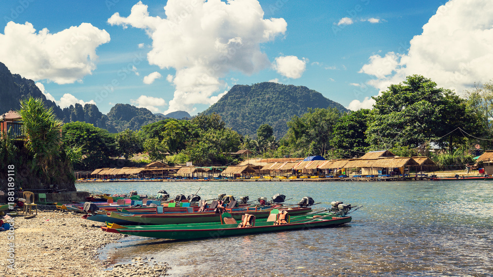 Fototapeta premium long tail boats on sunset at Song river, Vang Vieng, Laos.