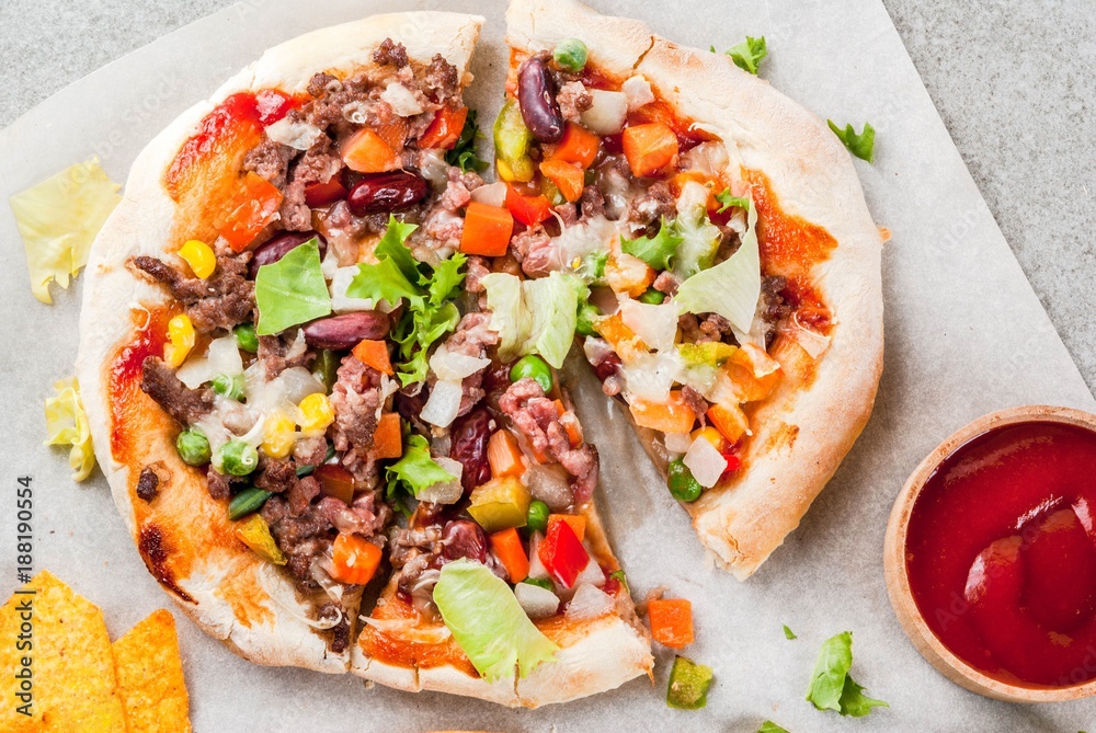 Homemade Mexican Taco PIzza with Nachos  chips, beans, fresh vegetables, beef meat, copy space