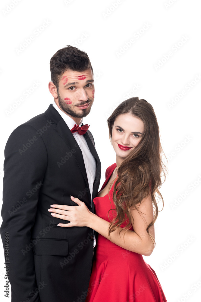 girlfriend hugging boyfriend with lips traces on face isolated on white girlfriend hugging boyfriend with lips traces on face isolated on white